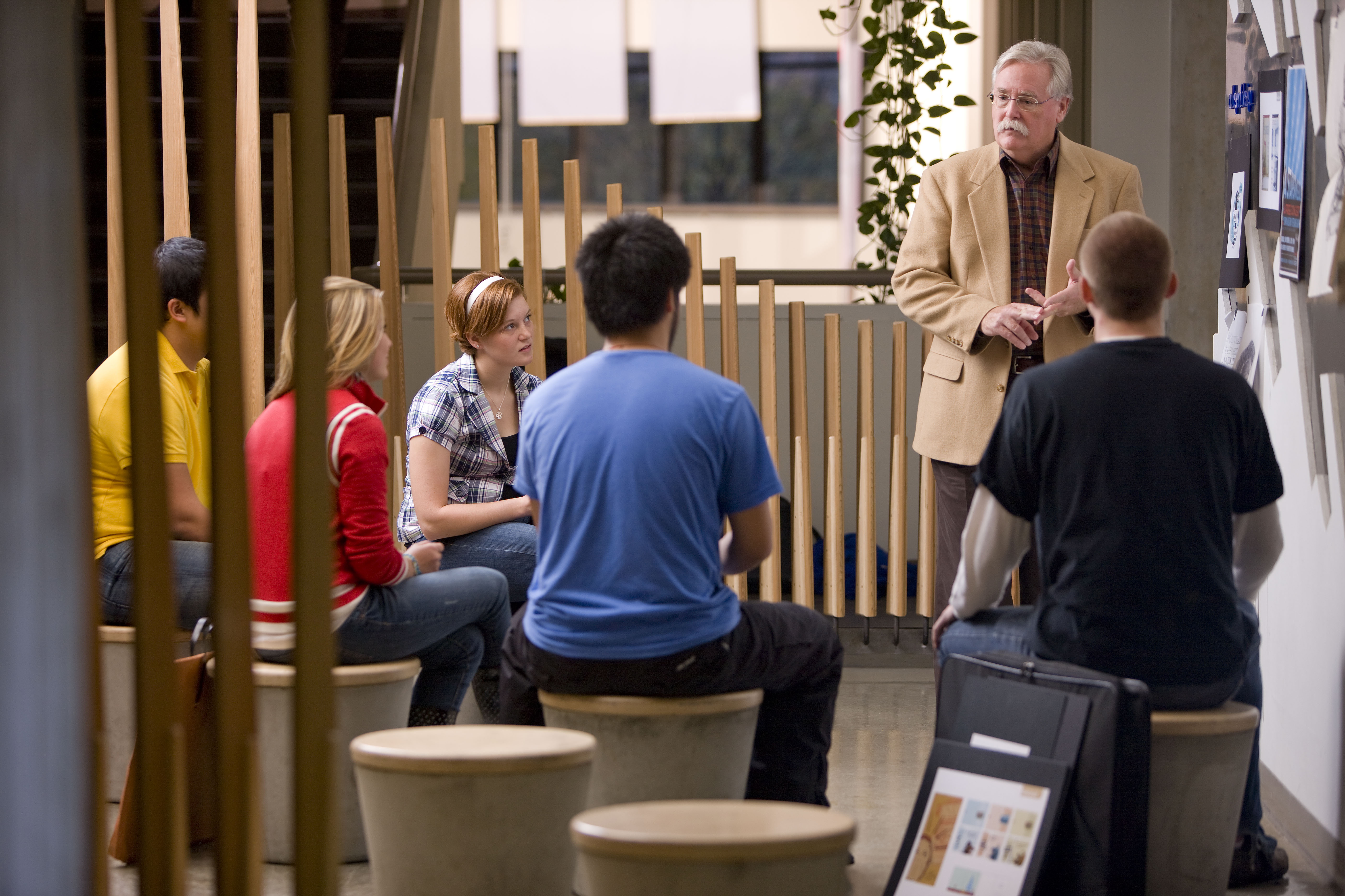 Professor and students participating in a critique.