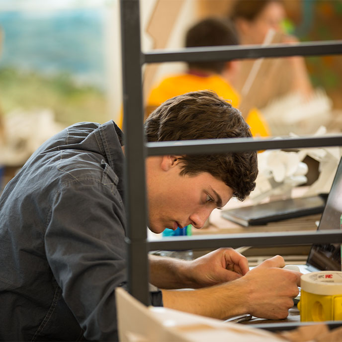 Iowa State student studying in front of his laptop.