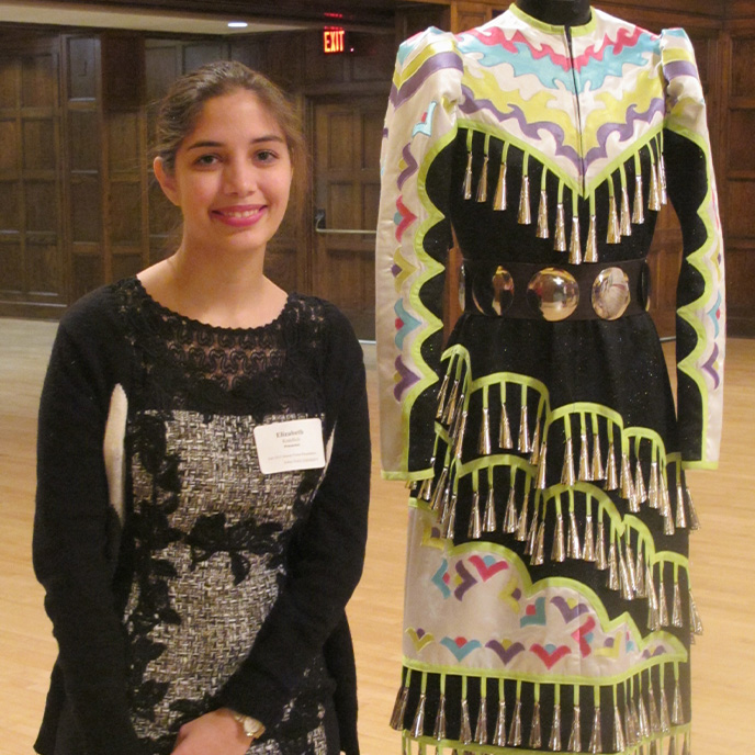 Female honors student presenting her honors project at the poster session.