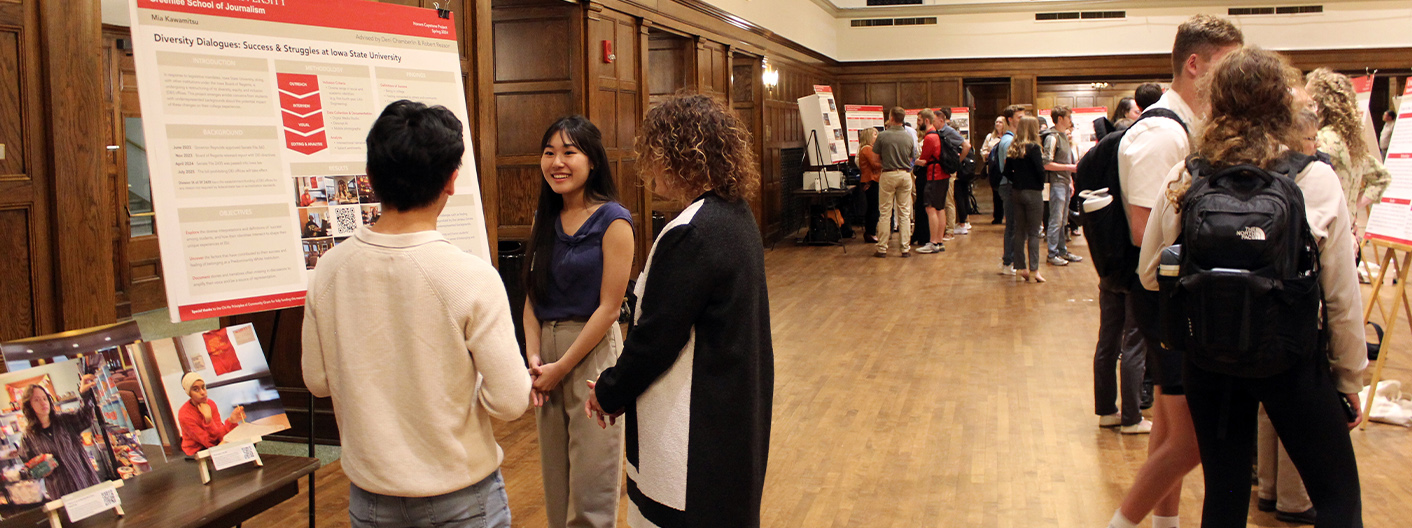 Mia Kawamitsu explains her poster project to Laurie Law and Luke Westrick at the Spring 2024 Poster Session.